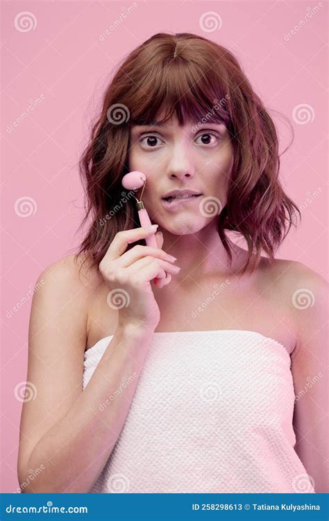 A Happy Woman Standing On A Pink Background With Pink Lighting From