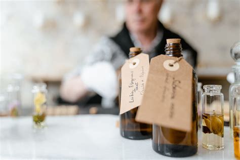 Brown Glass Bottles with Tags on White Table · Free Stock Photo