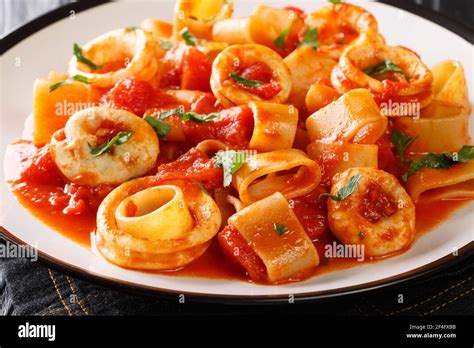 Italian Calamarata Pasta With Calamari And Tomato Sauce Close Up In A