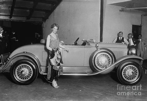 Amelia Earhart Posing With Automobile by Bettmann