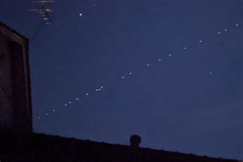 Mysterious string of lights spotted hovering in the sky baffles ...