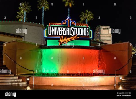 The Universal Studios Hollywood sign above an illuminated fountain ...