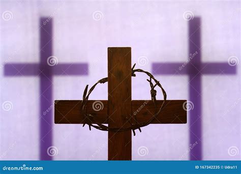 Abstract Easter Wooden Cross And Crown Of Thorns On Purple Background