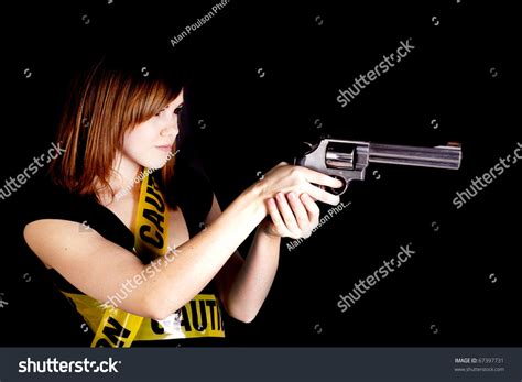 Woman pointing gun at goldfish stock photo - menscrm