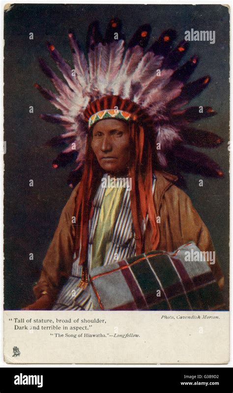 Elderly Iroquois Chief Wearing A Feathered Headdress And Carrying A