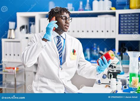 African American Man Scientist Talking On Smartphone Holding Pepper At