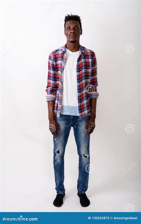 Full Body Shot Of Young Black African Man Standing Against White Stock