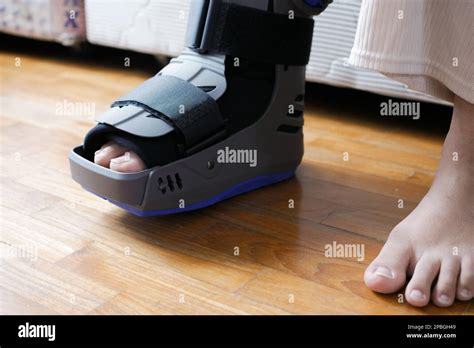 Women Broken Feet With A Grey Plastic Boot Ankle Brace Injury