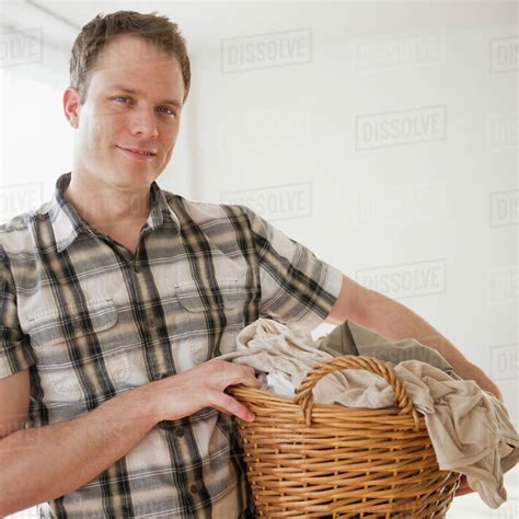 Caucasian Man Holding Laundry Basket Stock Photo Dissolve