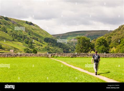 A Man Walking At Muker In Swaledale In North Yorkshire England