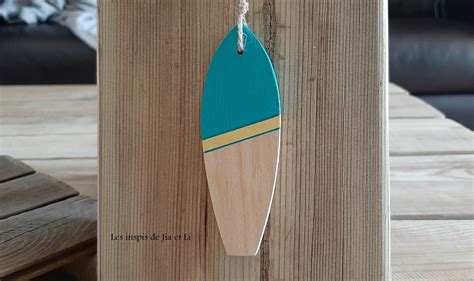 A Wooden Surfboard Hanging On The Side Of A Table