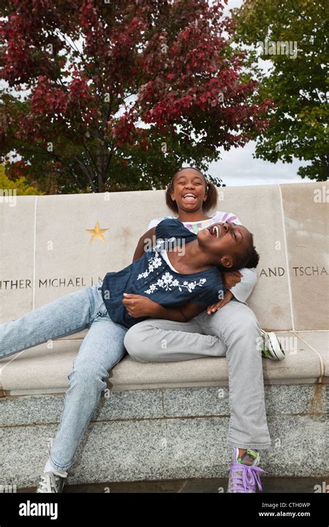 Laughing Black Girls Sitting On Bench Stock Photo Alamy