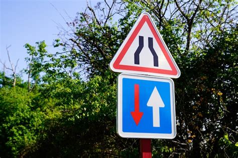 Premium Photo Sign Indicating A Narrowing Of The Road In France