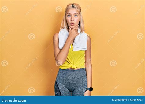 Beautiful Blonde Sports Woman Wearing Workout Outfit Looking Fascinated