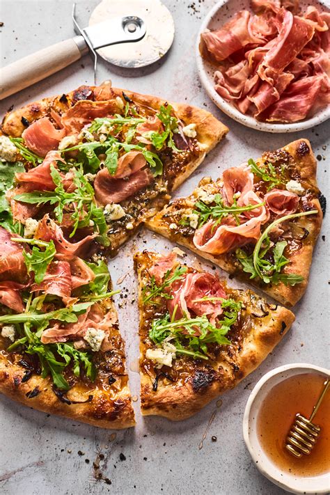 Fig Prosciutto Gorgonzola And Arugula Pizza With Hot Honey Olive And Mango