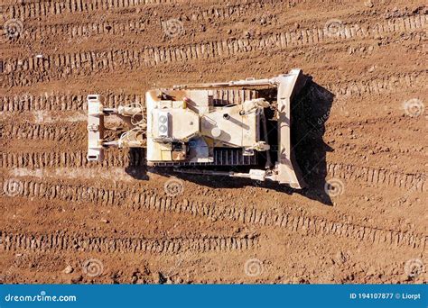 Bulldozer Pushing Large Amount Of Fresh Soil Aerial Shot Stock Image