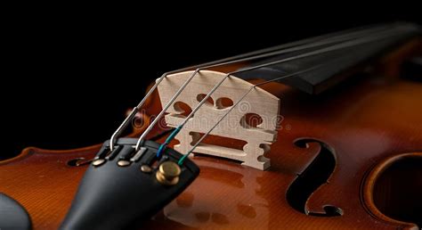 close   violin bridge  fine tuners intricate detail stock