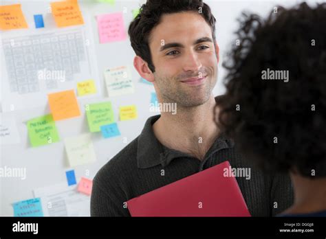 Female And Male Office Workers Chatting Stock Photo Alamy