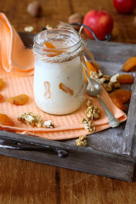 Homemade Yogurt And A Jar With Dried Apricots And Nuts Stock Image