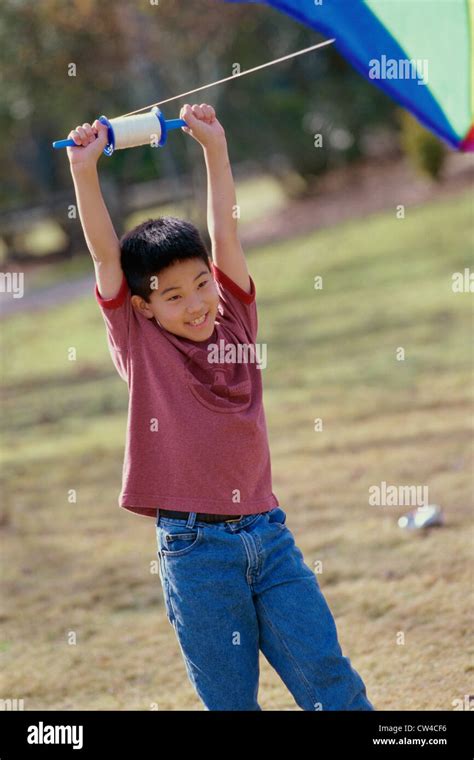 Boy Flying A Kite Stock Photo Alamy