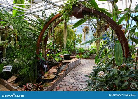 Tropical Greenhouse Oasis With Archway Pathway Eye Level View