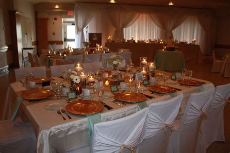 The Tables Are Set With Gold Plates And Silverware For An Elegant