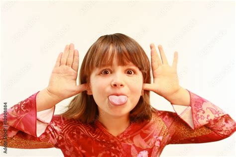 Cute Young Girl With Tongue Sticking Out Stock Photo Adobe Stock