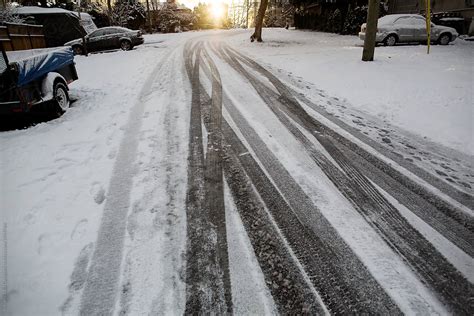 "Winter Tire Tracks On Snow Covered Road" by Stocksy Contributor "Rob And Julia Campbell" - Stocksy