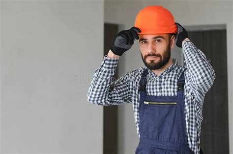 Portrait Of Handsome Mechanic With Stubble In Blue Overall Shirt