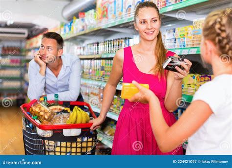 Cheerful Woman And Teenager Girl In The Grocery Shop Male On Backdrop