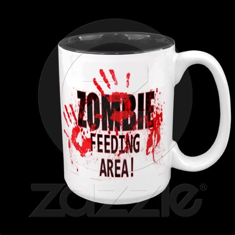 A White Coffee Mug With The Words Zombie Feeding Area On Its Front And