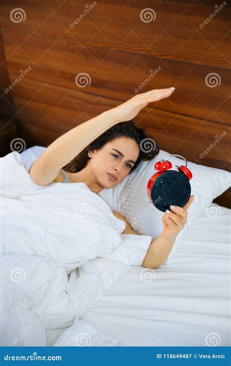 Woman Sleeping And Wake Up To Turn Off The Alarm Clock In The Morning