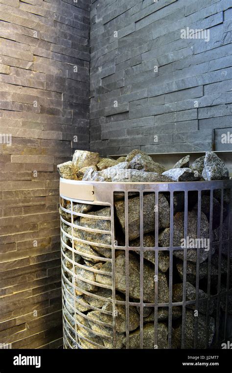 Sauna stove with stone wall on background in Finnish sauna Stock Photo ...