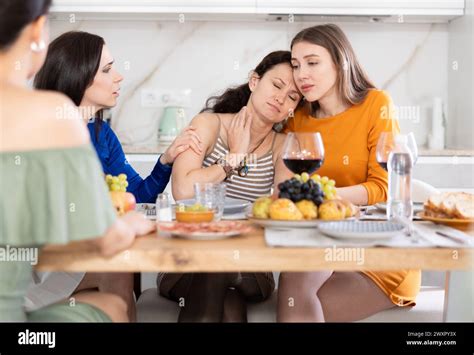 Female Friends Comforting Upset Woman At Home Gathering Stock Photo Alamy