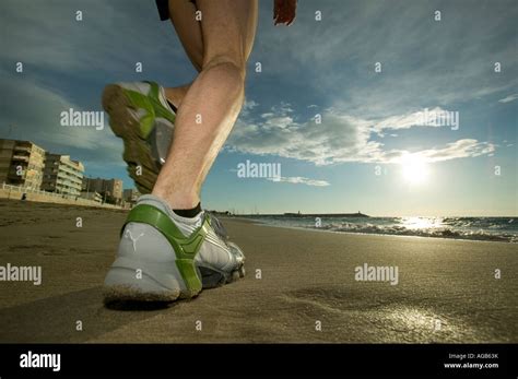 Close up of male runner s feet on beach Stock Photo - Alamy