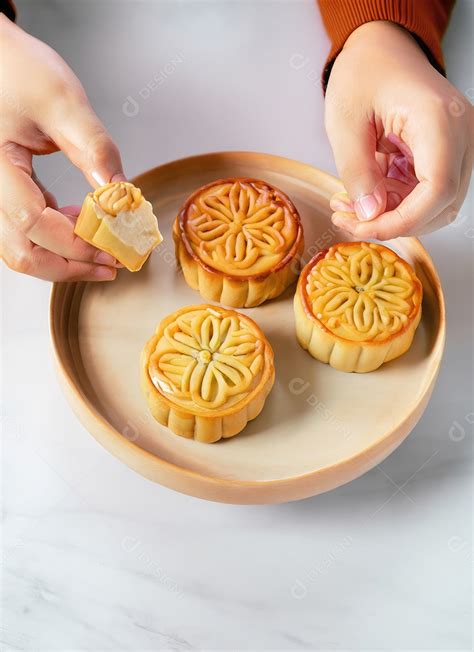 Mãos de pessoas comendo saborosos bolos redondos de lua no festival do