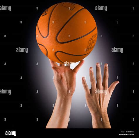 Two hands going for the basketball, tip off/ jump ball Stock Photo - Alamy