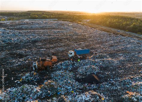 Garbage truck unloads rubbish in landfill. Landfill waste disposal ...