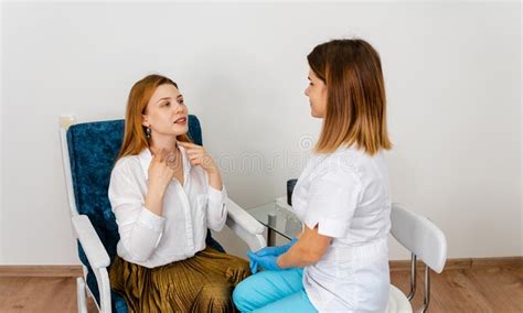 Doctor Listening Carefully Beautician Examining Face Skin Of Female