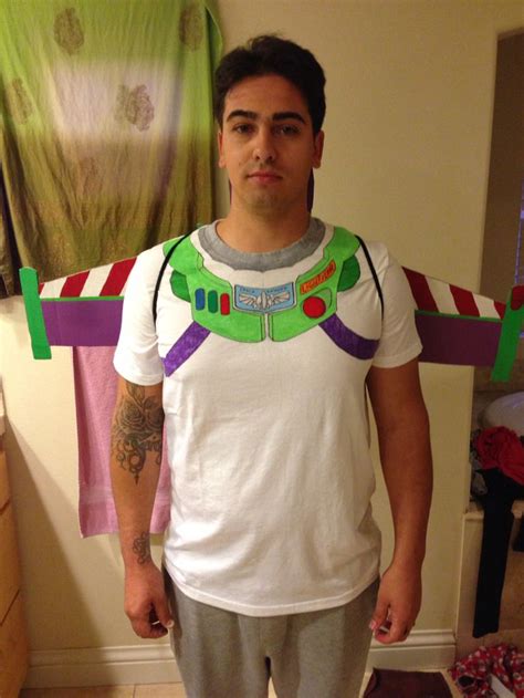 A Man Wearing A Toy Story Buzz Lightyear Costume Standing In Front Of A Bed