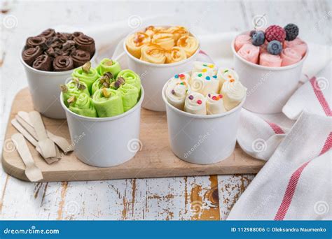 Selection Of Different Rolled Ice Creams In Cone Cups Stock Photo