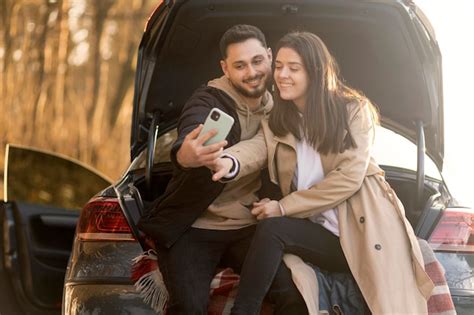 Premium Photo Smiley Couple Taking Selfie Medium Shot