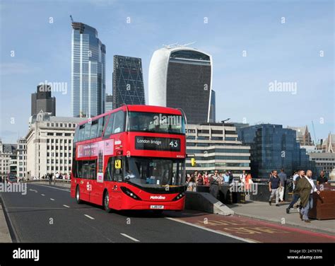 An electric (battery powered) double decker bus crossing London Bridge ...