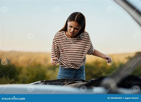 The Woman Driver Of The Car Broke Down The Car Pulls Out The Dipstick