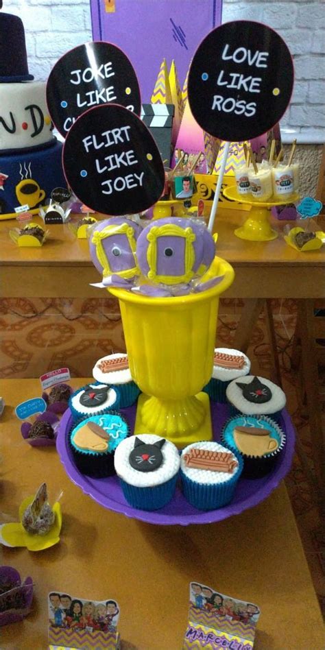 a table topped with lots of cupcakes covered in frosting