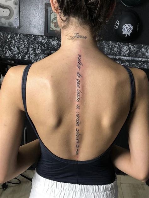 The Back Of A Woman S Neck With A Tattoo On Her Left Shoulder And Words