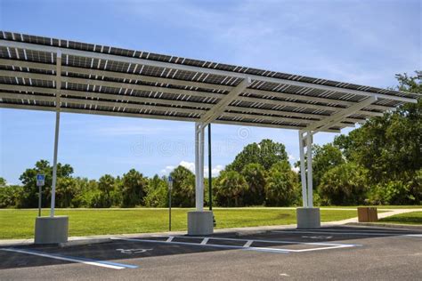 Solar Panels Installed As Shade Roof Over Parking Lot For Parked