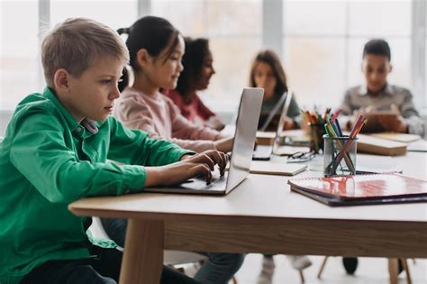 Menino Usando Laptop Sentado Colegas Multi Tnicas Na Sala De Aula