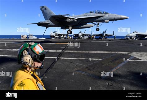 An F A 18f Super Hornet Is Seen Landing On The The Uss Ronald Reagan Off The Coast Of