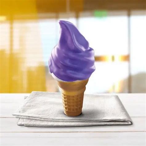 A Purple Ice Cream Cone Sitting On Top Of A Napkin